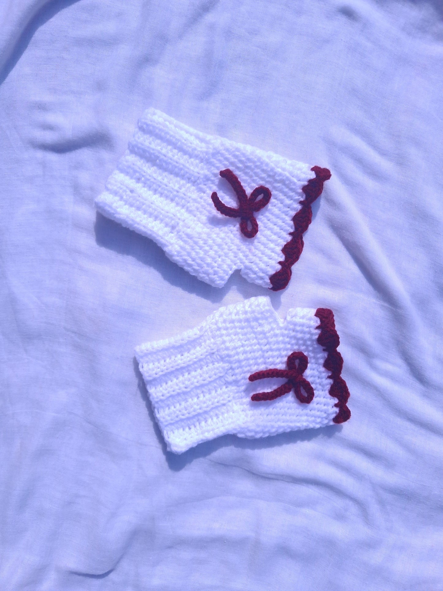 White hand warmers with red bow